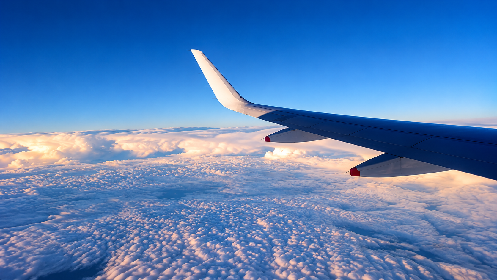 Airplane wing above the clouds